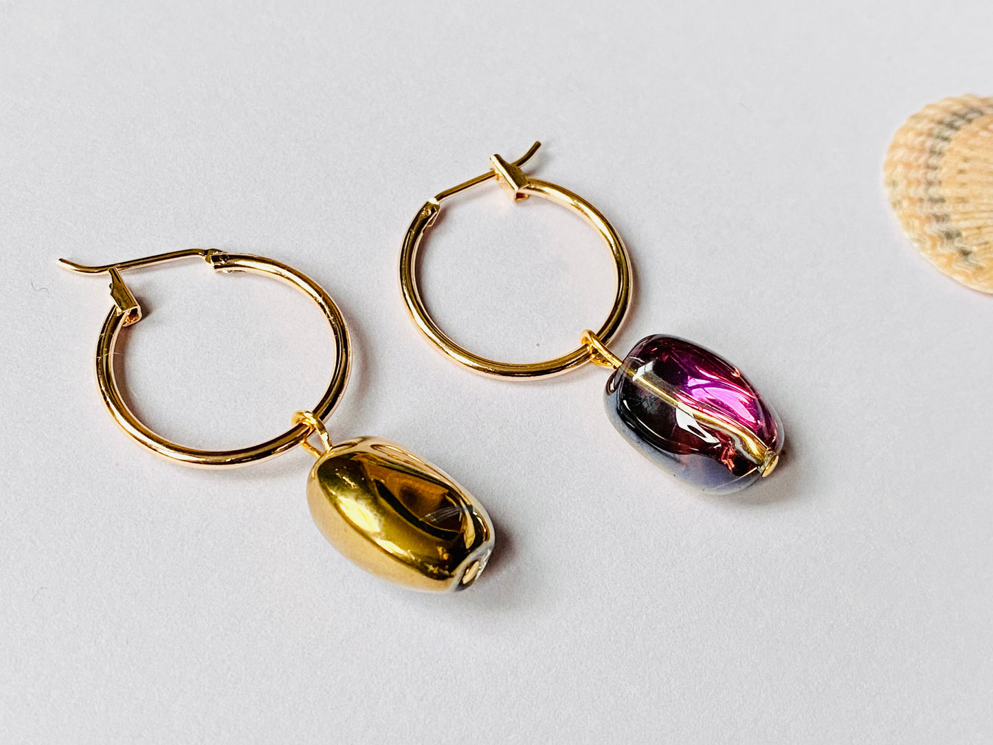 Gold plated hoops with shiny electroplated gold / pink hue glass beans. Perfect gift.