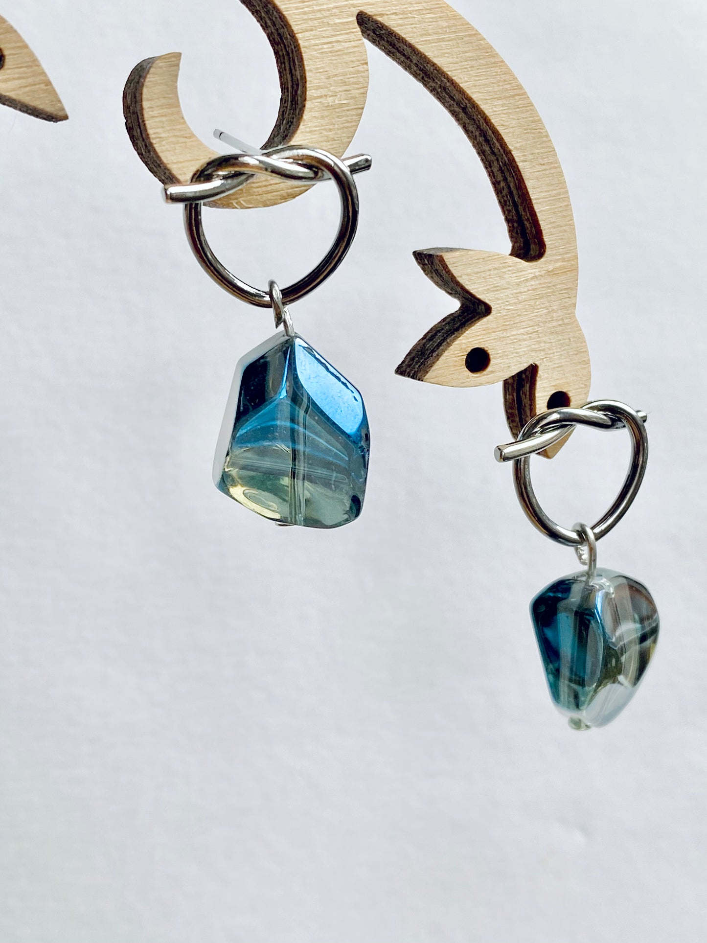 Silver plated knotted hoops with shiny unusual nugget electroplated blue / green hue glass beans. Perfect gift.