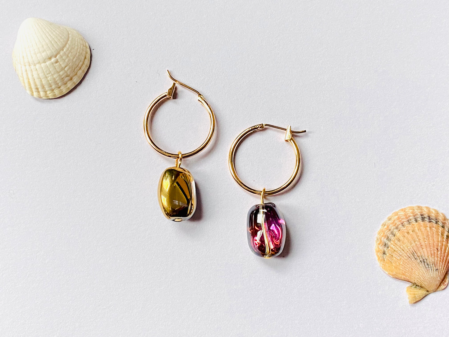 Gold plated hoops with shiny electroplated gold / pink hue glass beans. Perfect gift.