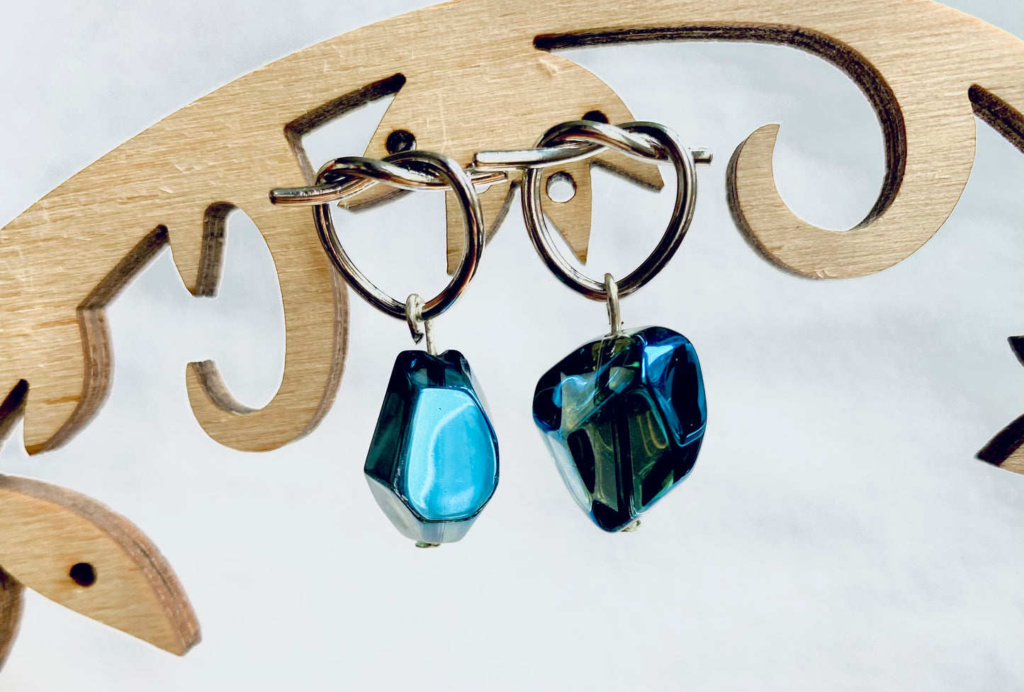 Silver plated knotted hoops with shiny unusual nugget electroplated blue / green hue glass beans. Perfect gift.