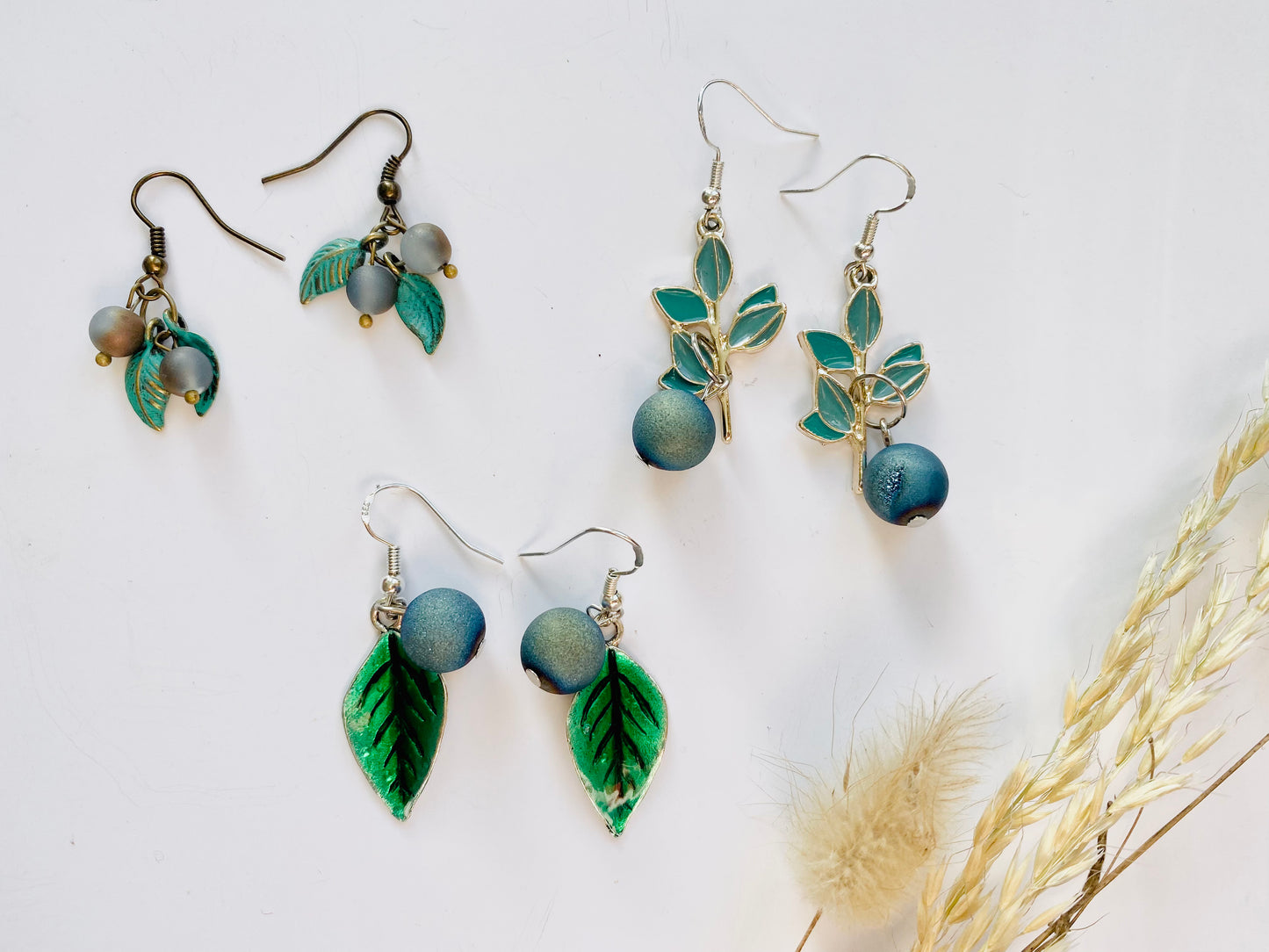 Handmade Sterling silver blueberry Druzy blue electroplated drop earrings with green leaf. Scandinavian nature inspired.