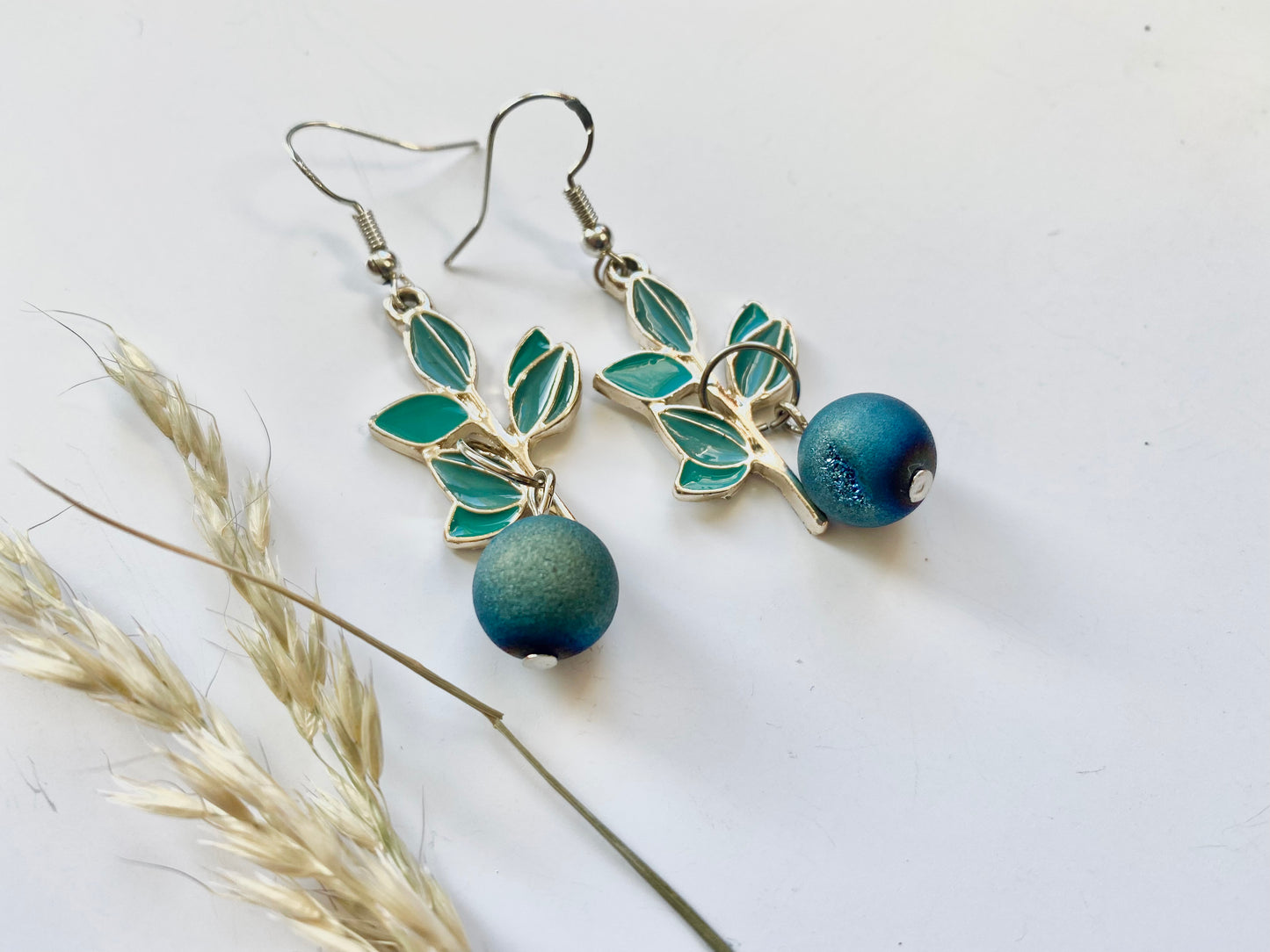 Handmade Sterling silver blueberry Druzy blue electroplated drop earrings with green leaf. Scandinavian nature inspired.